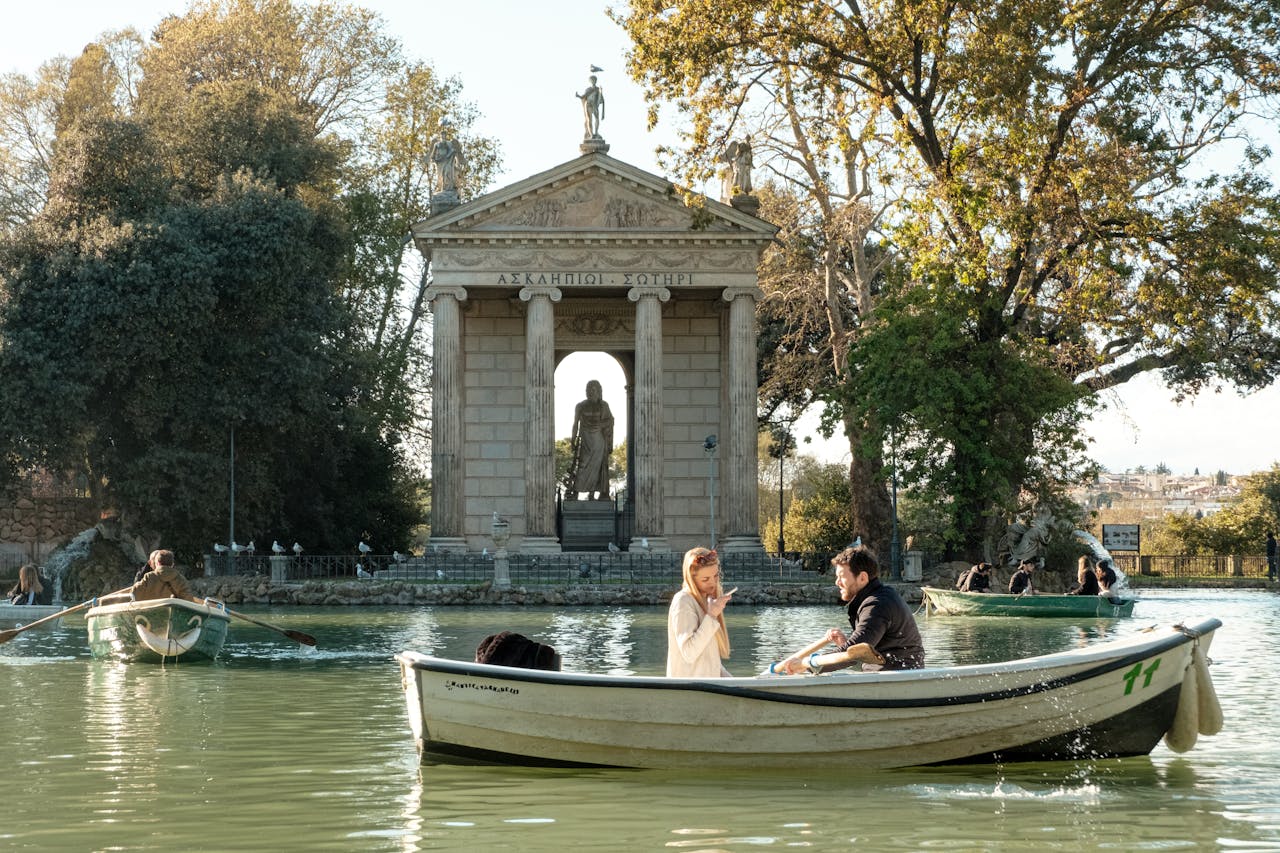 our-services-03 Couple enjoying a romantic boat ride near the Temple of Asclepius, Romes picturesque landscape.